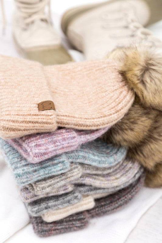 Assortment of cozy marled knit beanies with faux fur pom-poms, available in multiple colors.