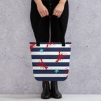 Model holding lobster print tote bag with black handles