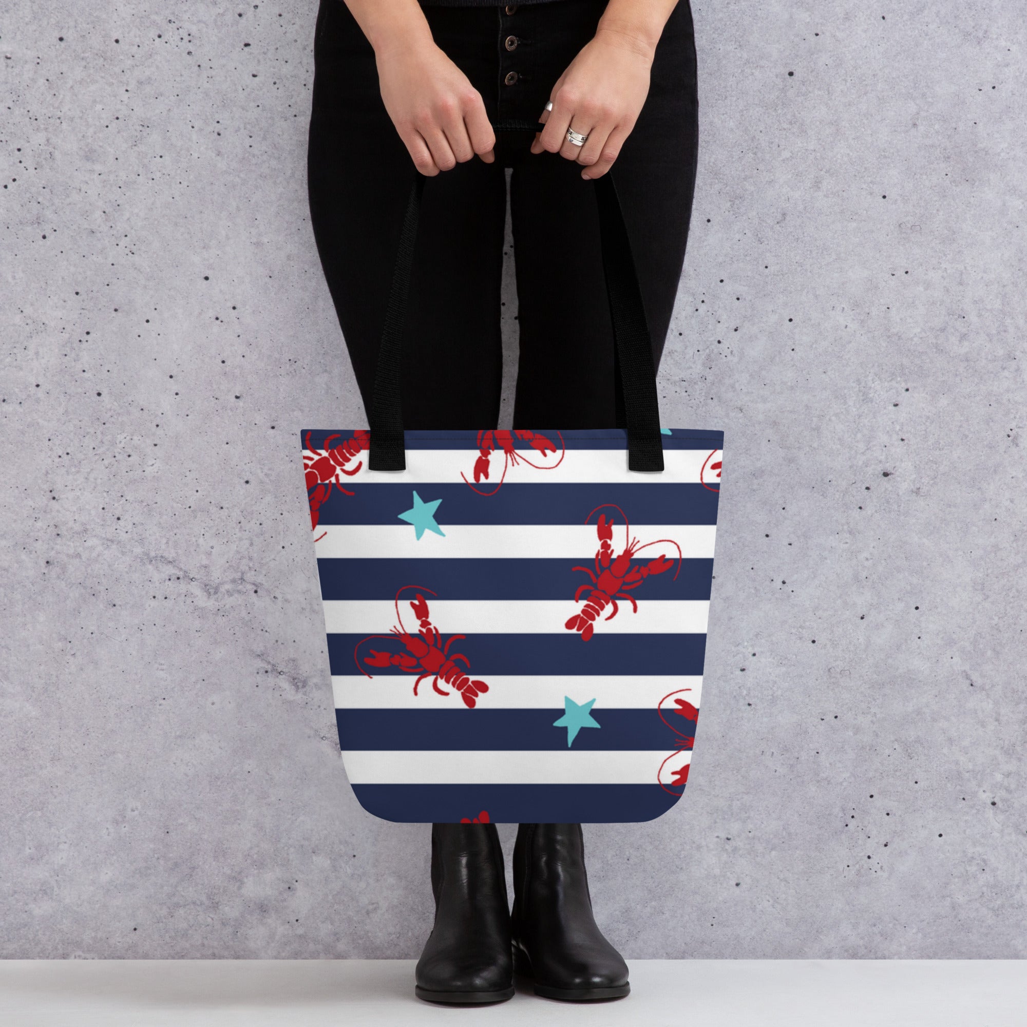 Model holding lobster print tote bag with black handles