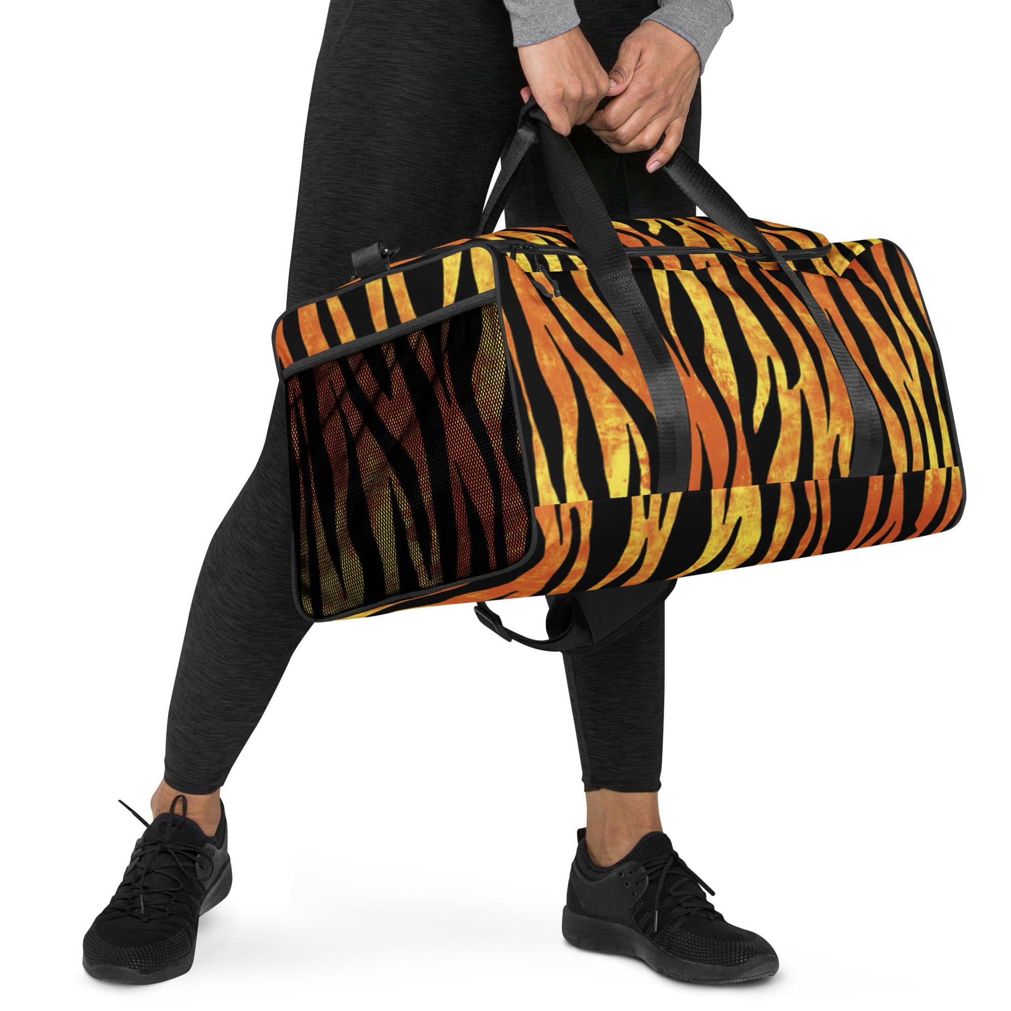 Side angle of tiger duffle bag worn crossbody