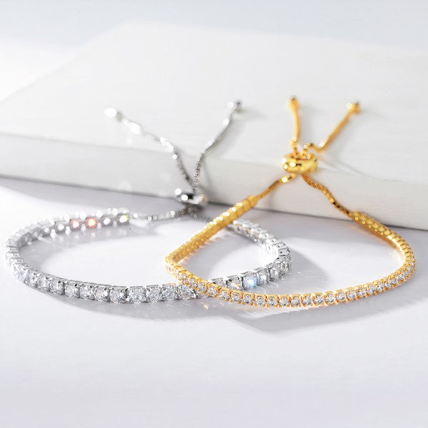 Stacked Alicia bracelets in gold and silver with adjustable cords