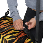 Tiger stripe travel bag being held by hand with mesh pocket visible