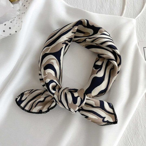 Versatile silk scarf folded on a white background