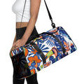 Woman carrying tropical duffle bag with toucan and floral design, black straps over shoulder

