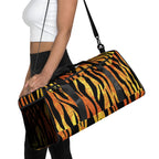 Woman holding tiger-striped duffle bag with shoulder strap