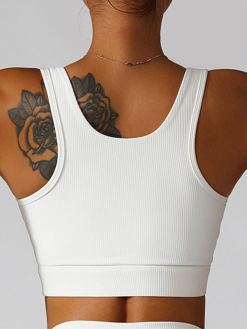 Model wearing Basic Bae Ribbed Square Neck Cropped Active Tank in white, showing back side view.