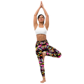 Woman wearing high-waist yoga leggings with a vibrant floral print on a black background, performing a tree pose in a white sports bra. Designed for comfort, flexibility, and activewear fashion.