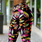 Women's high-waist yoga leggings with a bold and colorful floral print on a black background. Stretchy, moisture-wicking, and perfect for yoga and workouts.