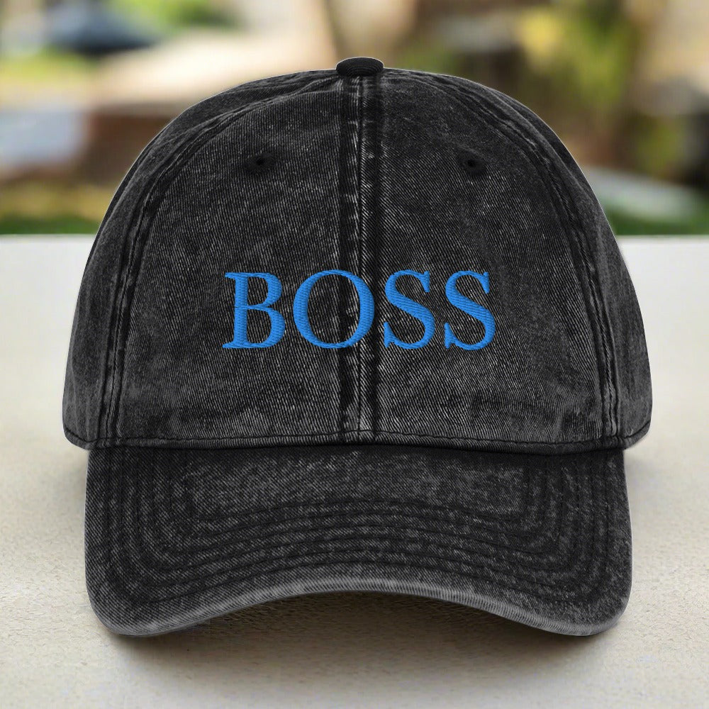 A stylish black vintage hat with the word 'boss' embroidered on it. Perfect for a cool and confident look.